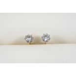 A PAIR OF DIAMOND STUD EARRINGS each set with a circular-cut diamond, in gold.