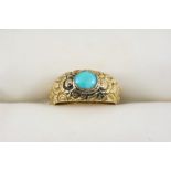 A VICTORIAN GOLD AND TURQUOISE RING the gold foliate engraved band is set with an oval turquoise