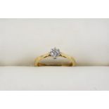 A DIAMOND SOLITAIRE RING the circular-cut diamond is set in 18ct. gold. Size O.