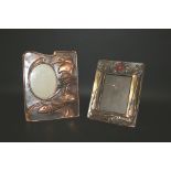 ARTS & CRAFTS PHOTOGRAPH FRAME a metal photograph frame with hand beaten decoration and an inset