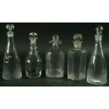 A PAIR OF SPIRIT DECANTERS of mallet form, together with three further decanters and stoppers,