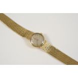 A LADY'S 18CT. GOLD WRISTWATCH BY OMEGA the signed circular dial with baton numerals, on an