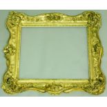 A FINE `DOUBLE` GILT PICTURE FRAME overall carved with with elaborately pierced scrolled motifs