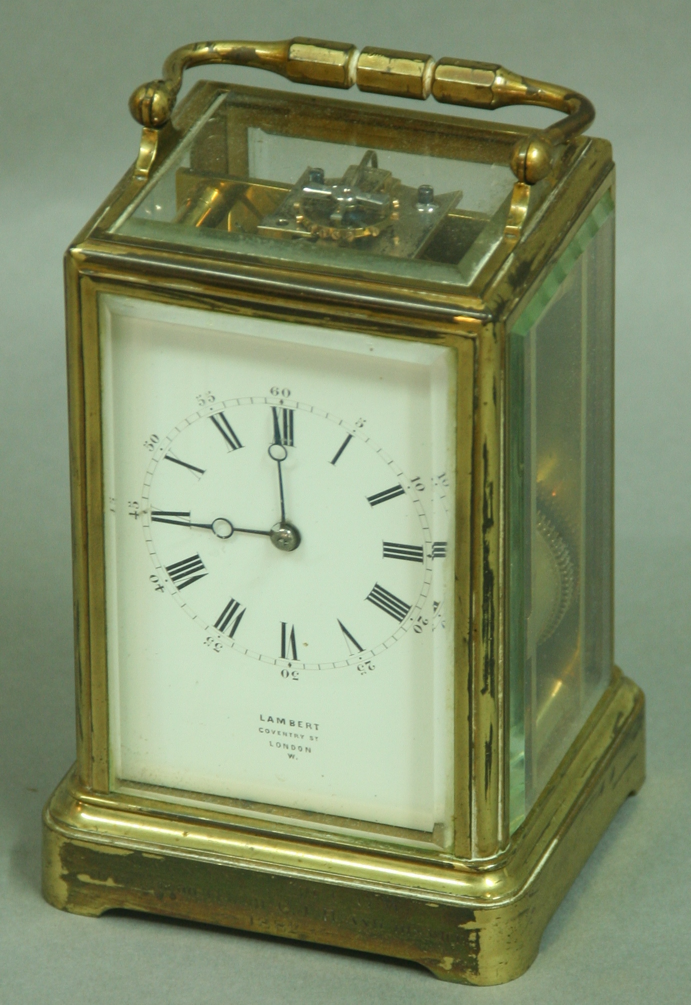 A GILT BRASS FOUR PANE CARRIAGE CLOCK the enamel dial inscribed Lambert, Coventry St., London,