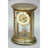 A BRASS FOUR PANE MANTLE CLOCK
movement striking on a coil with mercury filled pendulum in oval