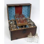 AN OAK CASED CAMPAIGN STYLE DECANTER SET, early 19th century, containing four six large and six