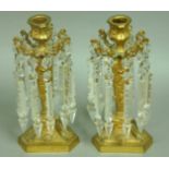 A PAIR OF ORMOLU CANDLESTICKS, mid 19th century, the central sconce surrounded by 10 lustres on a