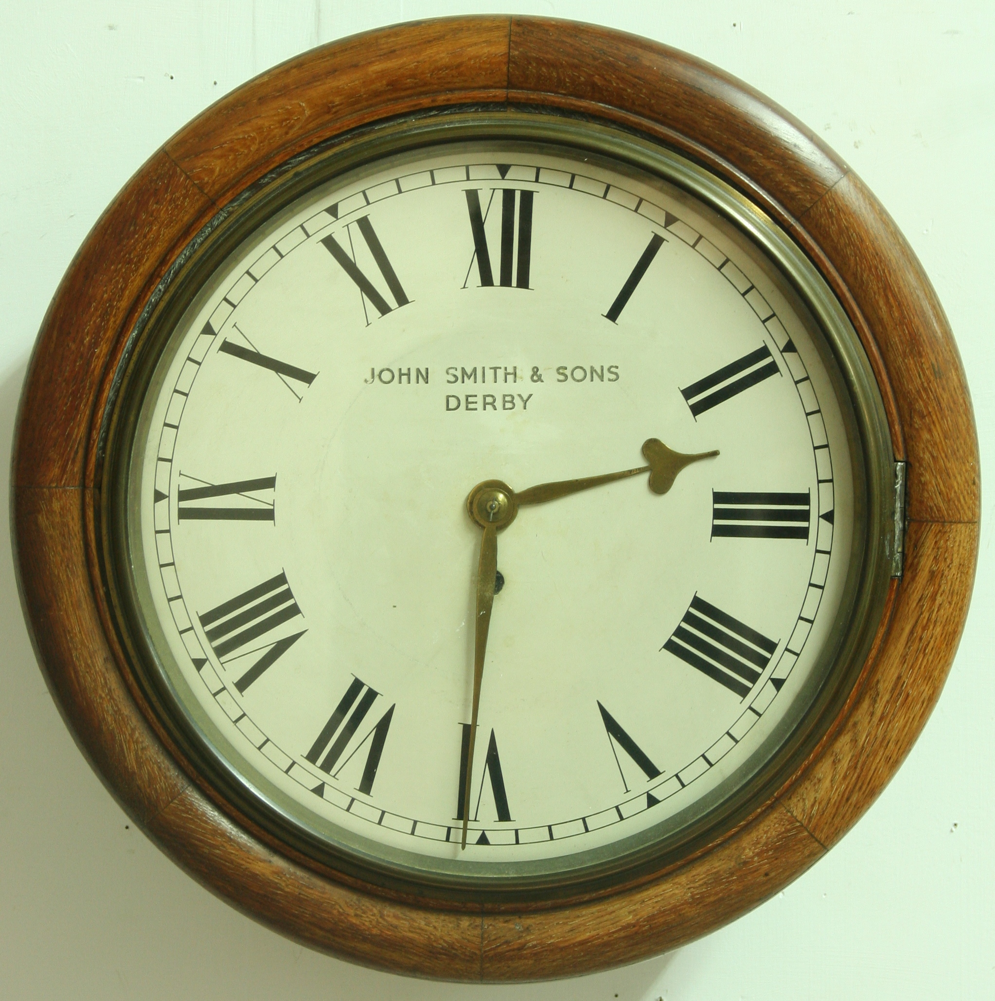 A VICTORIAN STATION CLOCK 11 1/2" dial, inscribed 'John Smith & Sons, Derby' on an eight day