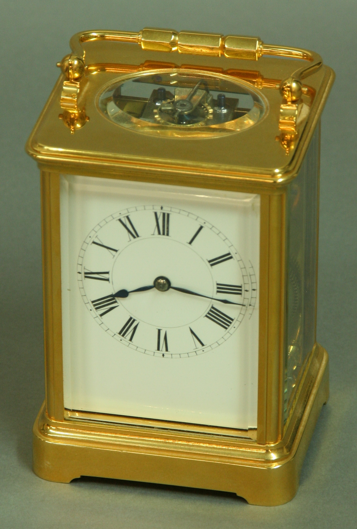 A FRENCH GILT BRASS FOUR PANE CARRIAGE CLOCK, late 19th century, white enamel dial, eight day