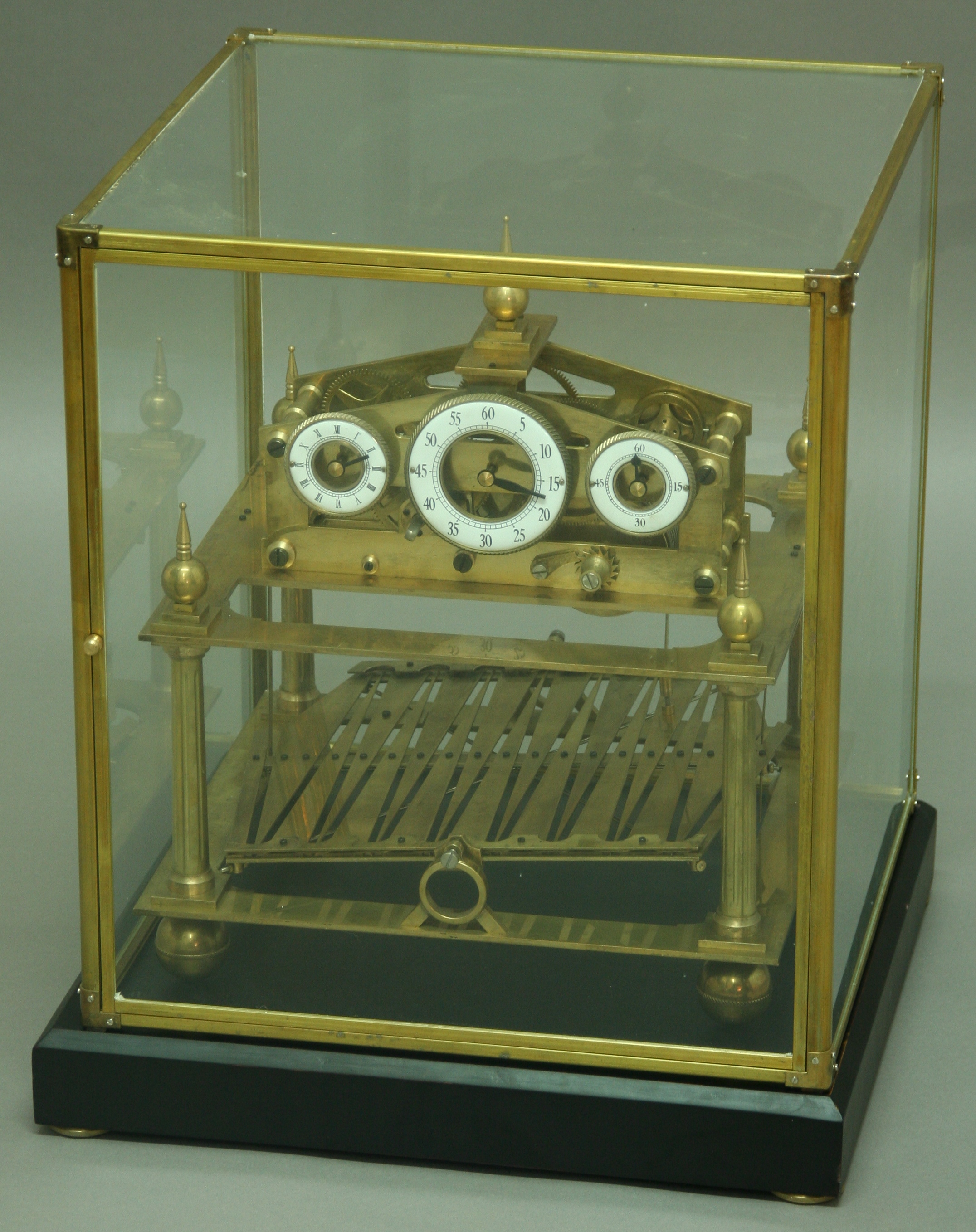 A BRASS CONGREVE ROLLING BALL CLOCK, 20th century, with triple enamelled dials on a single fusee