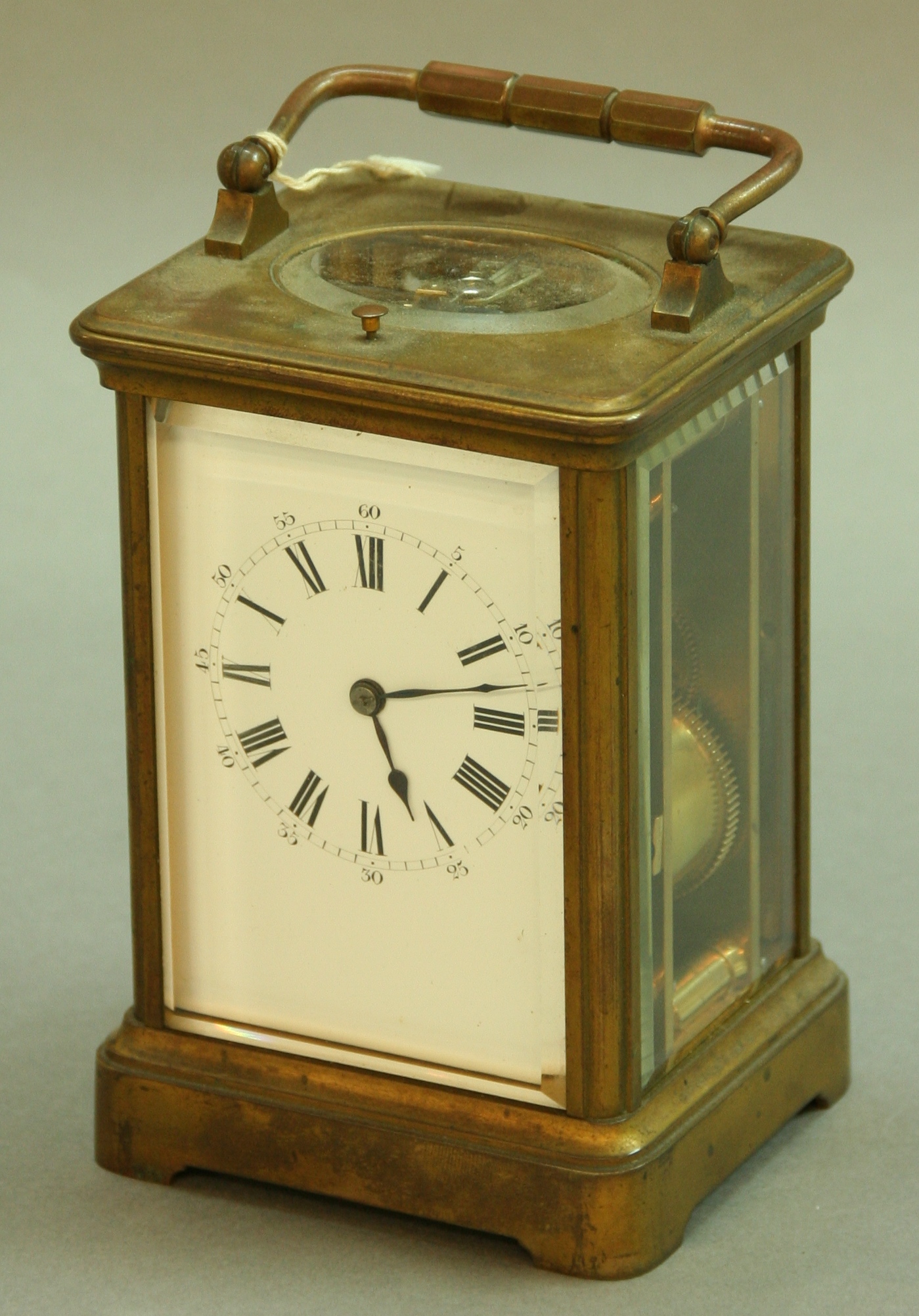 A FRENCH BRASS FOUR PANE CARRIAGE CLOCK the repeating movement stamped Paris, half-hourly striking