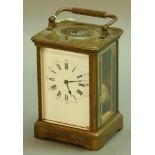 A FRENCH BRASS FOUR PANE CARRIAGE CLOCK the repeating movement stamped Paris, half-hourly striking