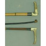 TWO SILVER MOUNTED HORN HANDLED RIDING CROPS together with another leather crop with dog head finial