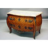 A COMMODE
of Louis XV design with serpentine bombe front and sides, the whole veneered with