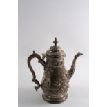 A GEORGE III BALUSTER COFFEE POT with embossed decoration and a replacement George II cover, the pot