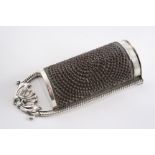 A GEORGE III "KITCHEN" NUTMEG GRATER with a foliate shell handle, gadrooned sides & hinged base,