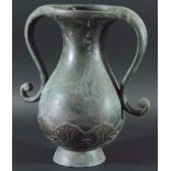 PERSIAN BRONZE TWO HANDLED VASE, of baluster form with long scrolling handles and a band of stylised