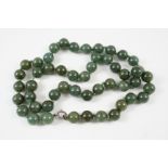 A SINGLE ROW UNIFORM JADE BEAD NECKLACE the beads measure approximately 13.3mm., 76cm. long.