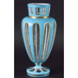 BOHEMIAN STYLE VASE, of baluster form in sky blue cut through to clear with gilt highlights, 26cm