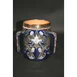 DOULTON LAMBETH TYG the 3 handled tyg designed with flowers and leaves on a dark blue ground, and