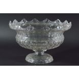 GLASS PUNCH BOWL, late 19th century, with castellated rim, faceted body and stepped foot, diameter