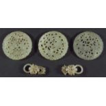 THREE CHINESE JADE TYPE DISCS, pierced with birds in foliage, 5.5cm; together with a pair of similar