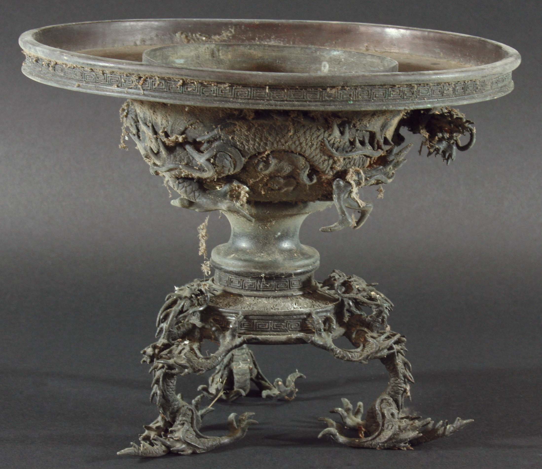 CHINESE BRONZE STAND, cast as shallow bowl decorated with dragons in relief, on a tripod base with