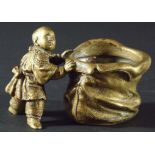 CHINESE BRASS BRUSH POT, modelled as a boy holding open a large sack, 11.5cm