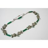 AN ENAMEL FLORAL AND SHELL NECKLACE the green enamel decoration set with small pearls, and with