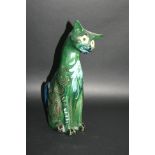 C H BRANNAM CAT a large pottery cat with glass eyes and green glazed body. Impressed marks, C H