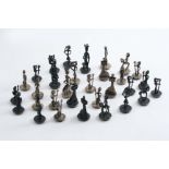 A LATE 20TH CENTURY CONTINENTAL CHESS SET with stylised figural pieces, each with a loaded base; the