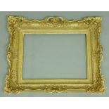 A GILT PICTURE FRAME with pierced and scrolled decoration of trailing flowers To fit canvas 47.5 x