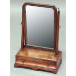 GEORGE II MAHOGANY TOILET MIRROR, the shaped rectangular mirror with bevelled edge on a base with