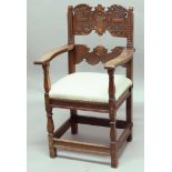 ITALIAN WALNUT ELBOW CHAIR, the carved back rest inscribed 1646 around a crest, scrolling arms,