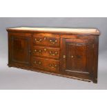 OAK DRESSER BASE, 18th century and later, a central frieze drawer above three central drawers