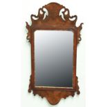 GEORGE II STYLE WALNUT WALL MIRROR, the shaped rectangular mirror with pierced frame, height 78cm,