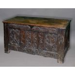 OAK COFFER, late 17th or early 18th century, the triple panel front with scrolling carved foliate