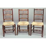 SET OF FIVE LANCASHIRE STYLE DINING CHAIRS, with spindle backs, rush seats and turned stretchers (
