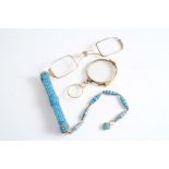 A GOLD LORGNETTE The case and chain studded with turquoise and with heart shape pendant, 21 cms