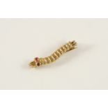 A GOLD CATERPILLAR BADGE with red glass eyes. 1.9cm. long. The Caterpillar Club badge was