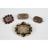 A GEORGIAN GARNET AND SEED PEARL MOURNING BROOCH the central compartment containing hair is set