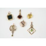 AN EDWARDIAN PERIDOT AND HALF PEARL PENDANT the 9ct. gold openwork pendant is mounted with two