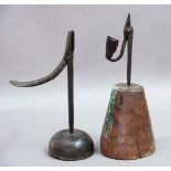WROUGHT IRON RUSH LIGHT HOLDER, 18th century, with candle socket on conical wooden base, 31cm;