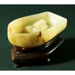 CHINESE JADE CARVING, possibly 18th century, of the drunken poet Li Bai or Li Po lying in a boat, on