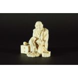 JAPANESE IVORY OKIMONO, Meiji, of a man standing with a fruit in one hand and a scroll in the other,