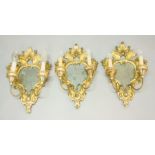 SET OF THREE FLORENTINE GILTWOOD GIRANDOLES, 19th century, the rococo shaped plate behind a pair