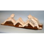 •RACHEL RECKITT (1908-1995) TWO SEATED FIGURES Cast concrete blocks upon a wooden base 27 x 99cm. ++