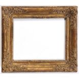 A LOUIS XV PICTURE FRAME with stylised leaf inner frame and outer moulding, the corners with