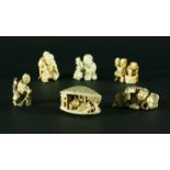COLLECTION OF SIX NETSUKE, to include a clam shell landscape, a man with a three legged toad and