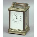 BRASS FOUR PANE CARRIAGE CLOCK, the enamelled dial on a brass eight day movement half hourly